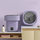 Mini Foldable Washing Machine in lavender color displayed on a countertop, showcasing its compact design for easy use.