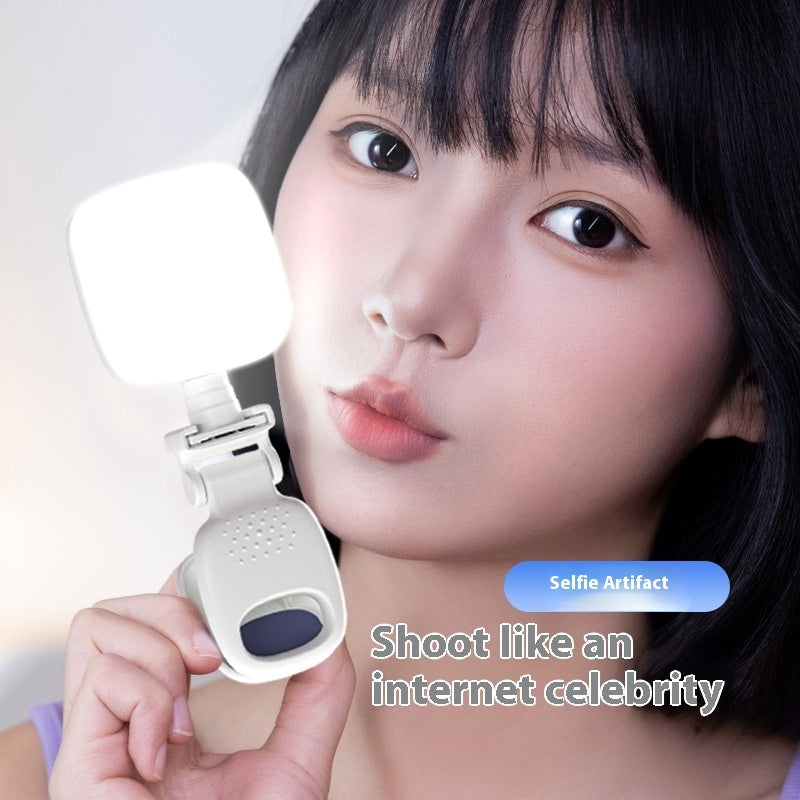 Mobile Selfie Fill Light attached to a phone illuminating a young woman&