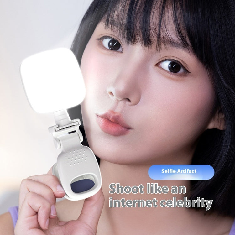 Mobile Selfie Fill Light attached to a phone illuminating a young woman&